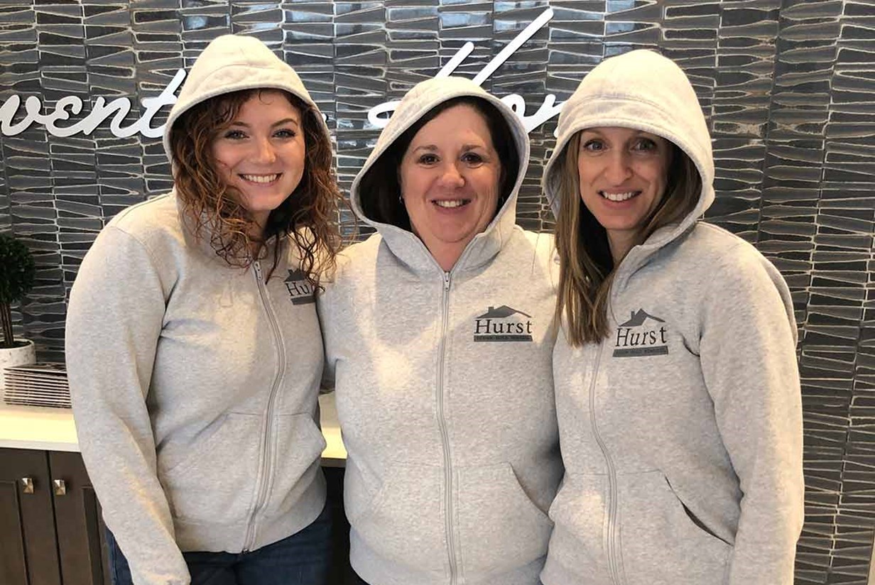 three Hurst designers in matching hoodies